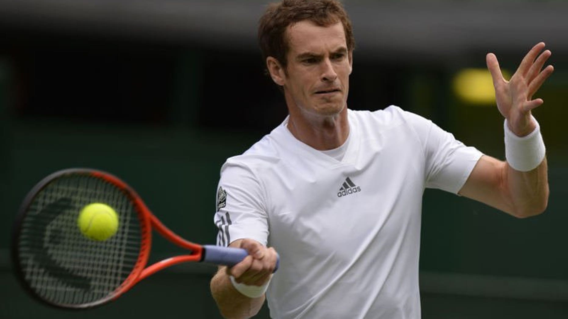 Britain's Andy Murray returns against Germany's Benjamin Becker during their men's first round match on day one of the 2013 Wimbledon Championships tennis tournament at the All England Club in Wimbledon, southwest London, on June 24, 2013. Murray made history as the world number two cruised into the Wimbledon second round with a 6-4, 6-3, 6-2 victory.