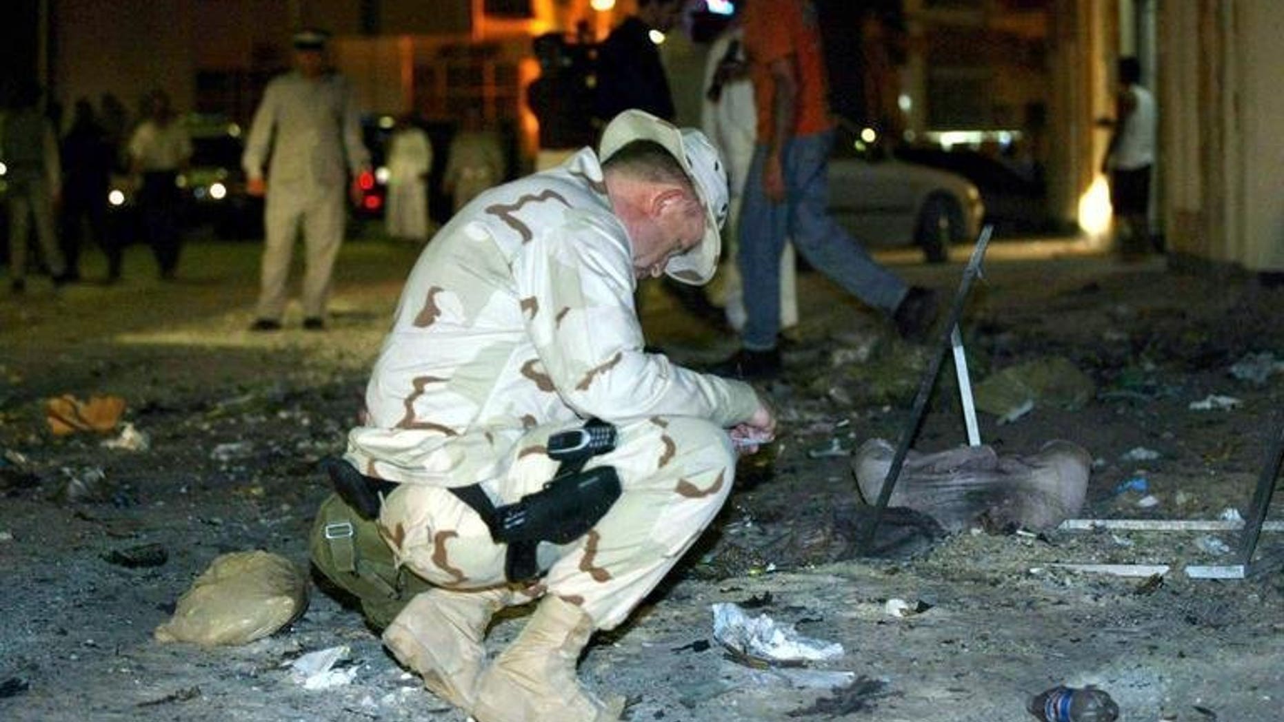A US Navy officer examines the scene of an explosion near the headquarters of the Navy's Fifth Fleet in Manama on March 24, 2003. The US military has failed to prepare a realistic "plan B" if political turmoil forces the closure of the vital naval base in Bahrain, a naval officer argues in a report released Monday.