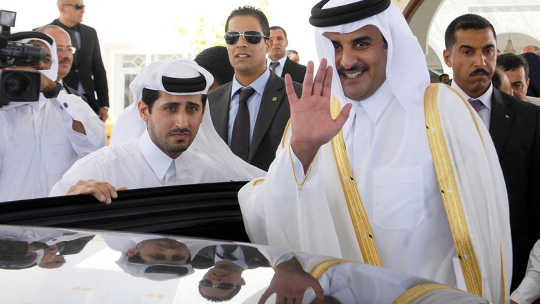 Sheikh Tamim bin Hamad al-Thani waves for photographers upon arrival in Tunis on July 16, 2012. Since his appointment as heir apparent a decade ago, Sheikh Tamim has held top security and economic posts, as well as overseeing Qatar's ambitious plans to use sports to raise its international profile.