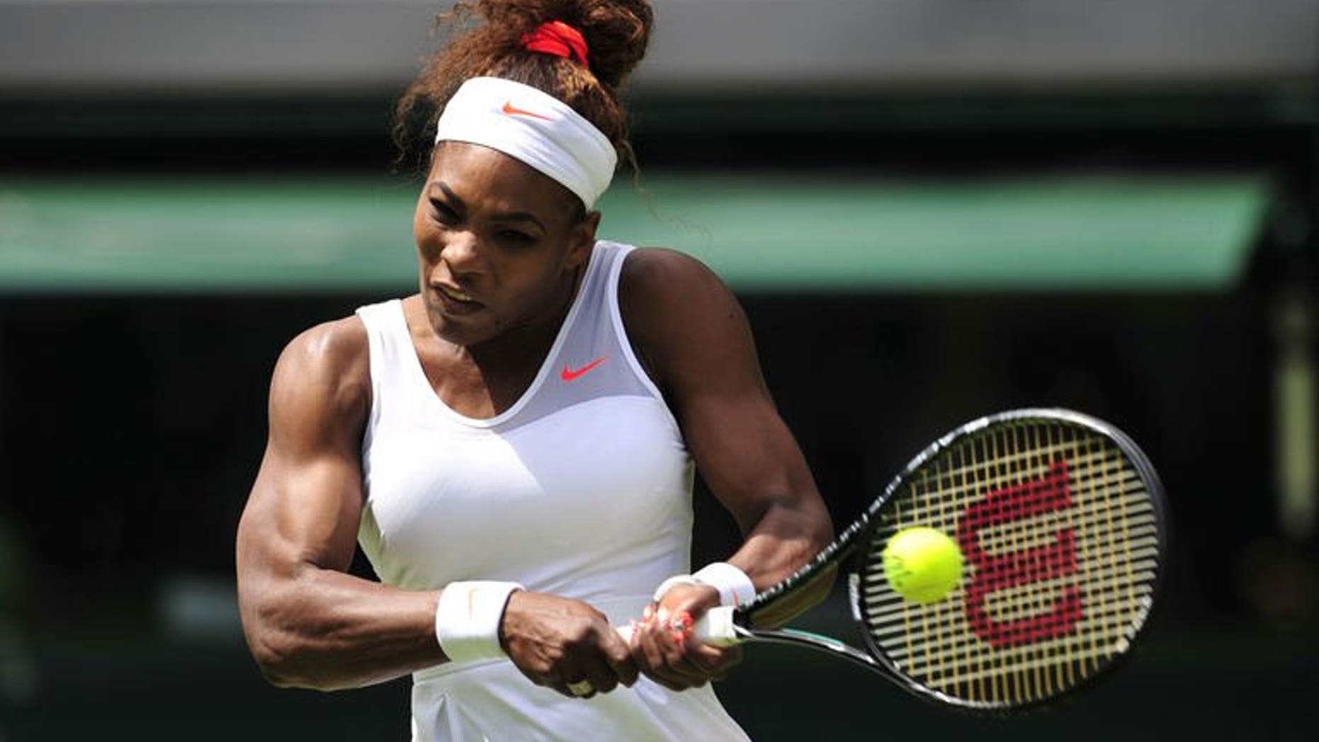 US player Serena Williams hits a return against Luxembourg's Mandy Minella during their women's first round match at the Wimbledon Championships in southwest London, on June 25, 2013. Williams reached the second round with a 6-1, 6-3 win over Minella.