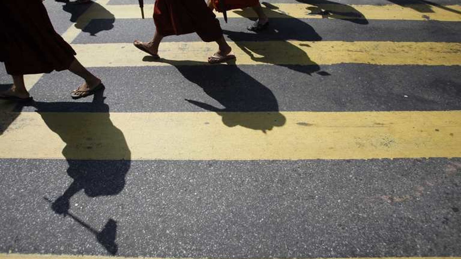 Myanmar Buddhist monks take part in a demonstration against the Organisation of the Islamic Conference in Yangon on October 15, 2012. Myanmar late Tuesday banned a controversial Time magazine cover story on Buddhist-Muslim religious violence "to prevent further conflict", according to a government spokesman, after days of angry reaction to the article.