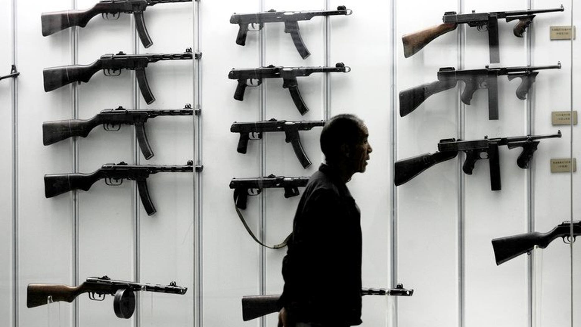 A visitor looks at a display of guns at the military museum in Beijing on June 13, 2006. Defence budgets in the Asia Pacific region will overtake the United States and Canada by 2021, according to a study by respected analysts IHS Jane's published on Tuesday.