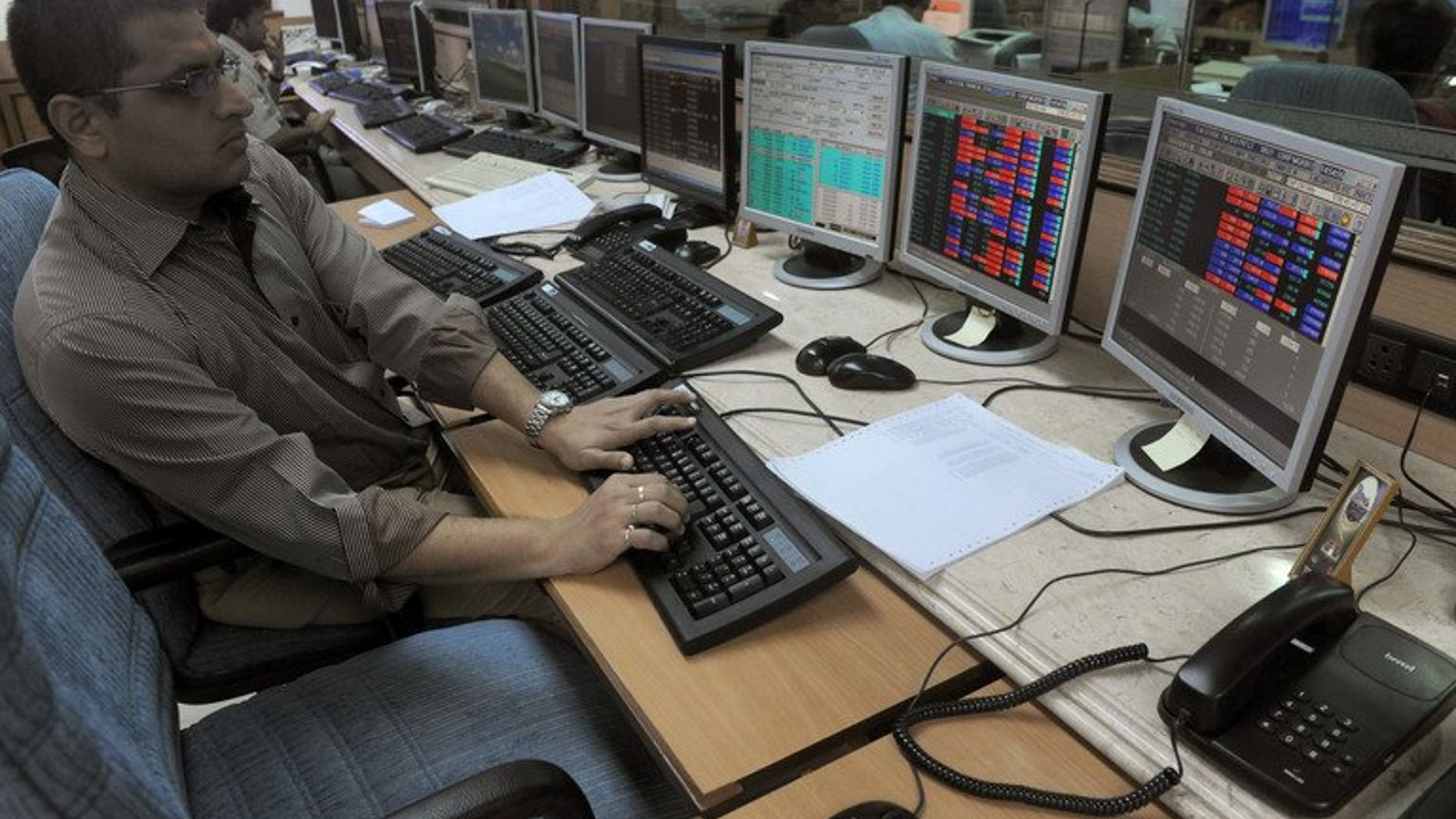 An Indian stockbroker watches share prices on trading terminals at a brokerage house in Mumbai on October 4, 2012. India's market regulator on Tuesday announced an overhaul of existing regulations for foreign investors, in a bid to attract crucial inflows to the country's capital markets.