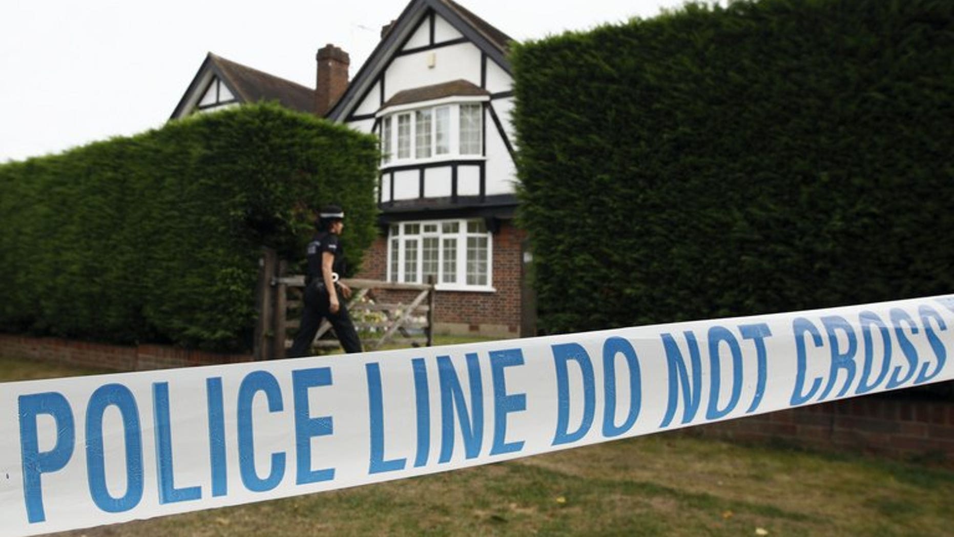 British police stand outside the home of Saad and Iqbal al-Hilli in Claygate, in Surrey, southeast England, on September 14, 2012. British police on Tuesday released on bail a suspect and brother of murdered British-Iraqi man, Saad al-Hilli, who was shot dead along with his wife, mother-in-law and a French cyclist in the Alps last year.