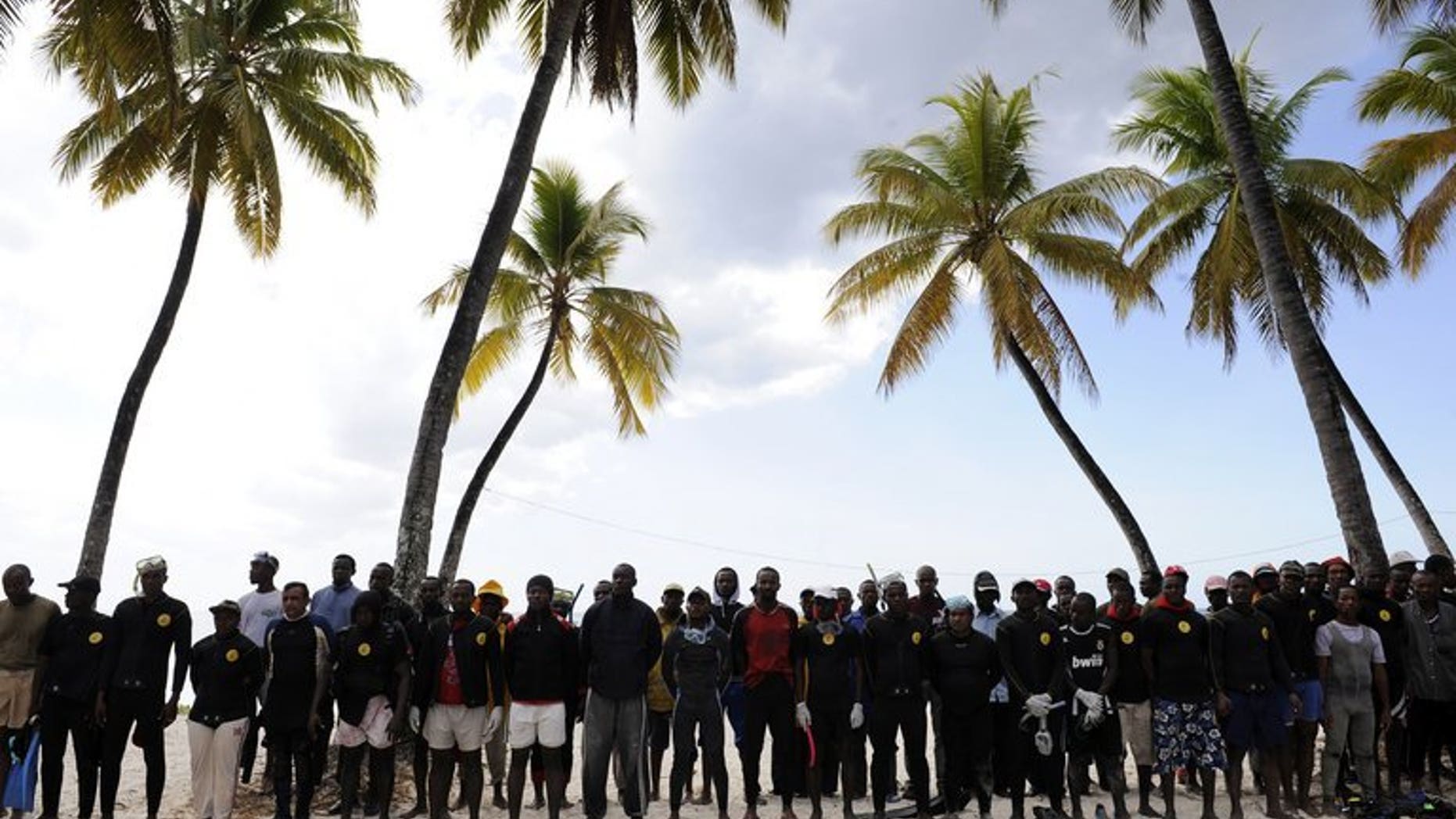 Divers wait on July 1, 2009, by a temporary emergency camp after a plane crash off the northern coast of the Comoros that killed 152 people. A final report into the 2009 crash has found the pilots were to blame for the accident, an investigative commission said on Tuesday.
