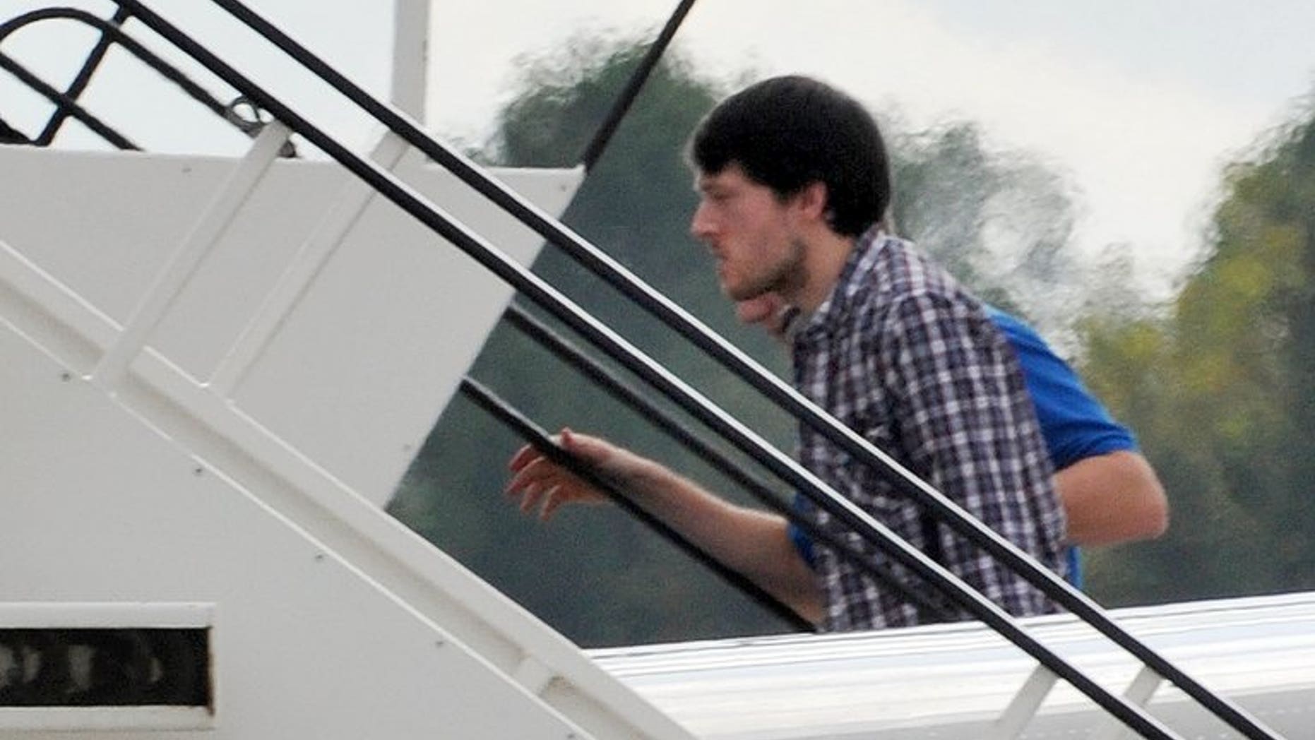 Jeremy Forrest, the British teacher who ran away with a 15-year-old pupil, is escorted in a plane to Britain on October 10, 2012. The wife of Forrest, who was sentenced to five-and-a-half years in prison for abducting a schoolgirl after they fled together to France, is seeking a divorce, his sister said Tuesday.