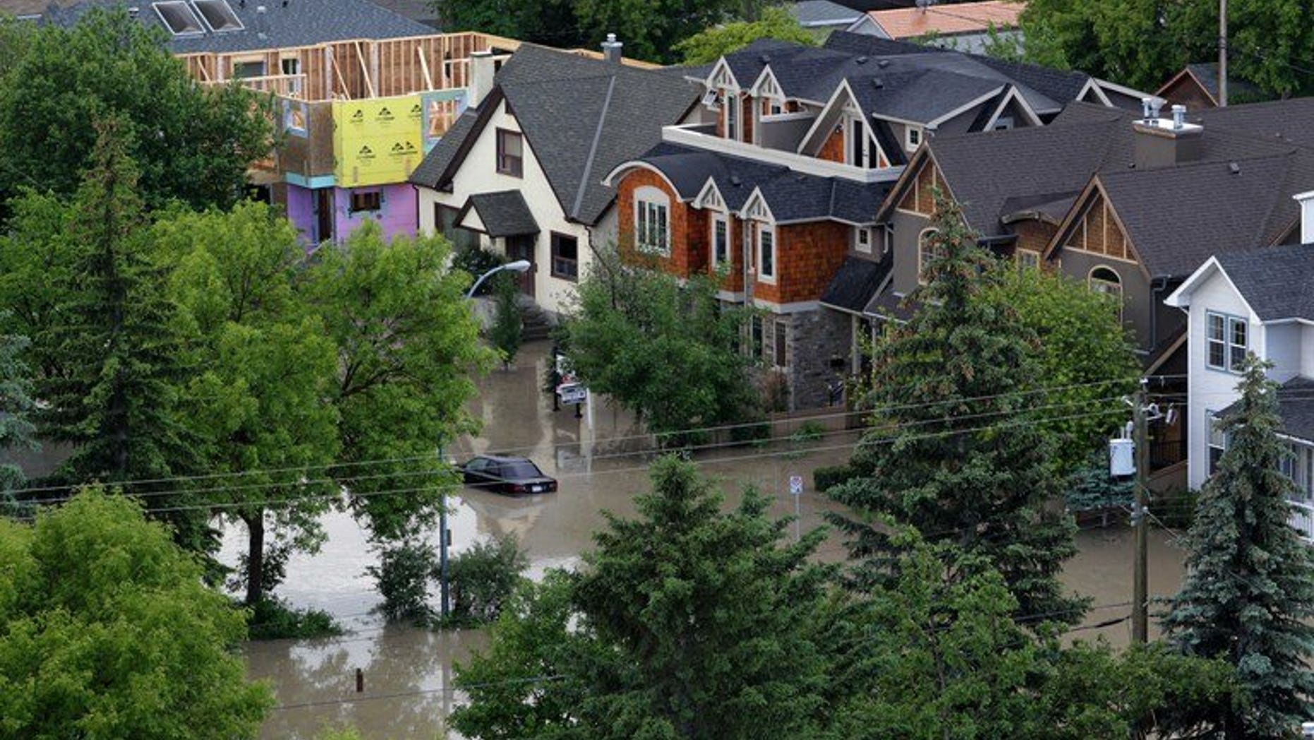 A neighbourhood beside the Bow River in Calgary, Alberta, Canada, is flooded on June 22, 2013. Canadian authorities upped the Alberta flood death toll to four Wednesday, after an autopsy revealed an 83-year-old woman had drowned in her ground-level apartment near the Elbow River.