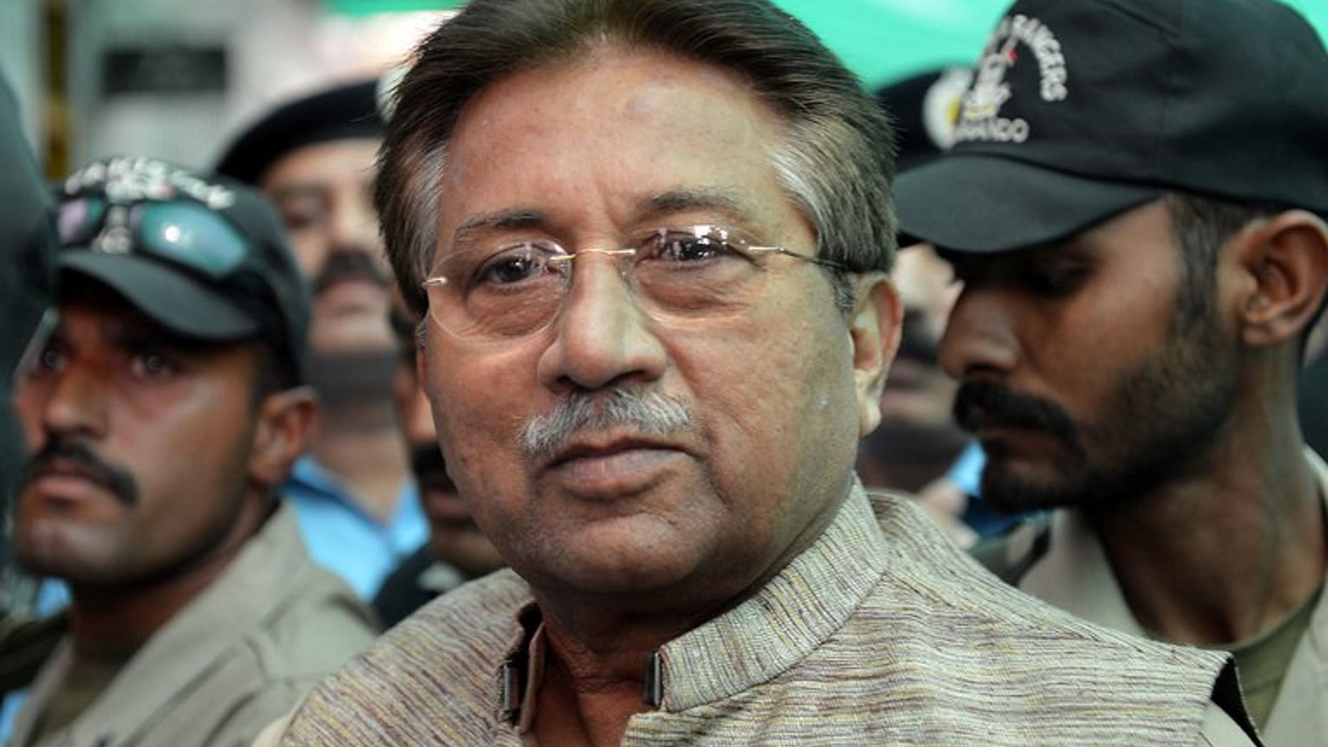In this photograph taken on April 20, 2013, former Pakistani president Pervez Musharraf (C) is escorted by soldiers as he arrives at an anti-terrorism court in Islamabad. Pakistan on Thursday moved a step closer to putting Musharraf on trial for treason, by appointing a committee to investigate him for subverting the constitution.