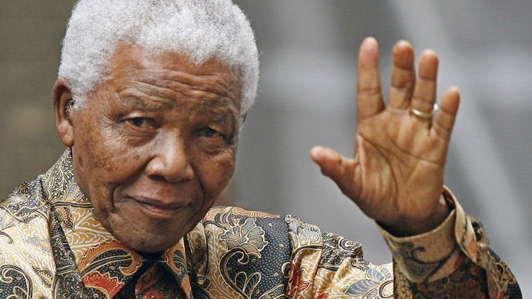 File picture taken on August 28, 2007 shows former South African president Nelson Mandela waving to the media as he arrives outside 10 Downing Street in London. Mandela remains in a "critical but stable" condition, South Africa's presidency said Monday, more than three weeks after the anti-apartheid hero was hospitalised with a recurring lung infection.