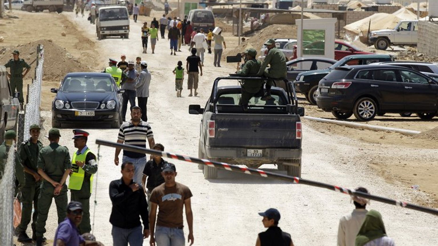Jordanian security guards patrol the entrance to Zaatari refugee camp, near the border with Syria, on August 15, 2012.