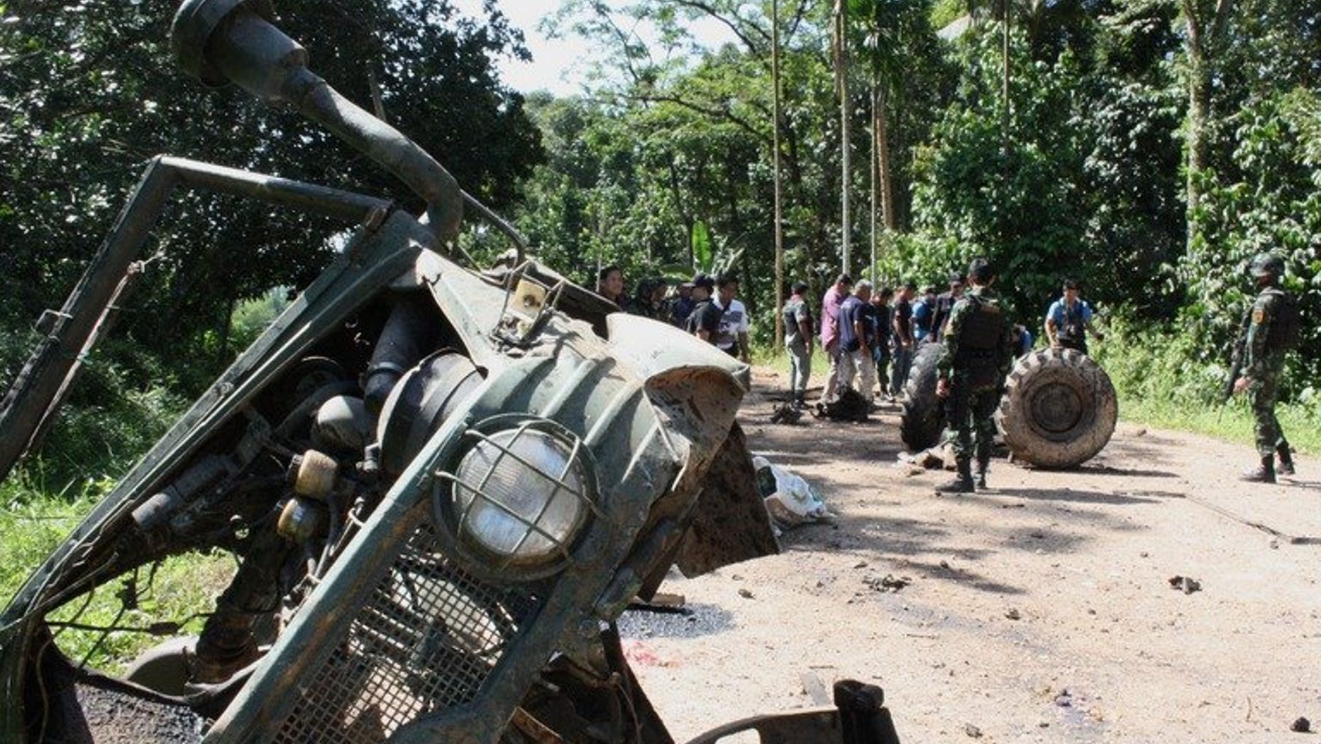 Thai security forces inspect the site of a roadside bomb attack in the restive southern province of Yala on June 29, 2013. Eight soldiers were killed, an army spokesman said, raising questions over the durability of a fragile peace process aiming to end the near-decade long insurgency.