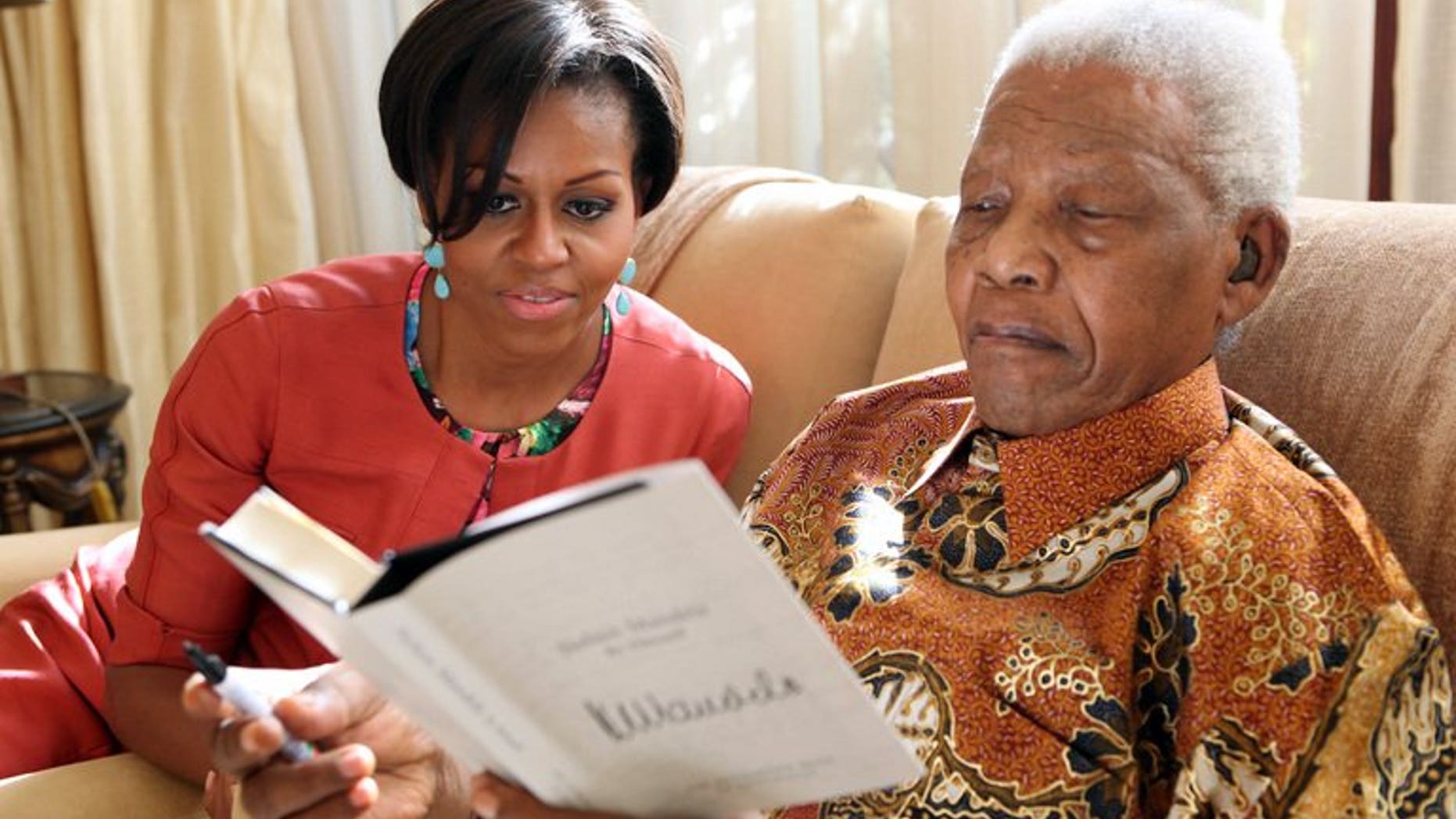 Nelson Mandela with Michelle Obama at Mandela's home in Johannesburg in 2011. US President Barack Obama on Saturday hailed the "moral courage" of Nelson Mandela, which he said was an inspiration to the world.