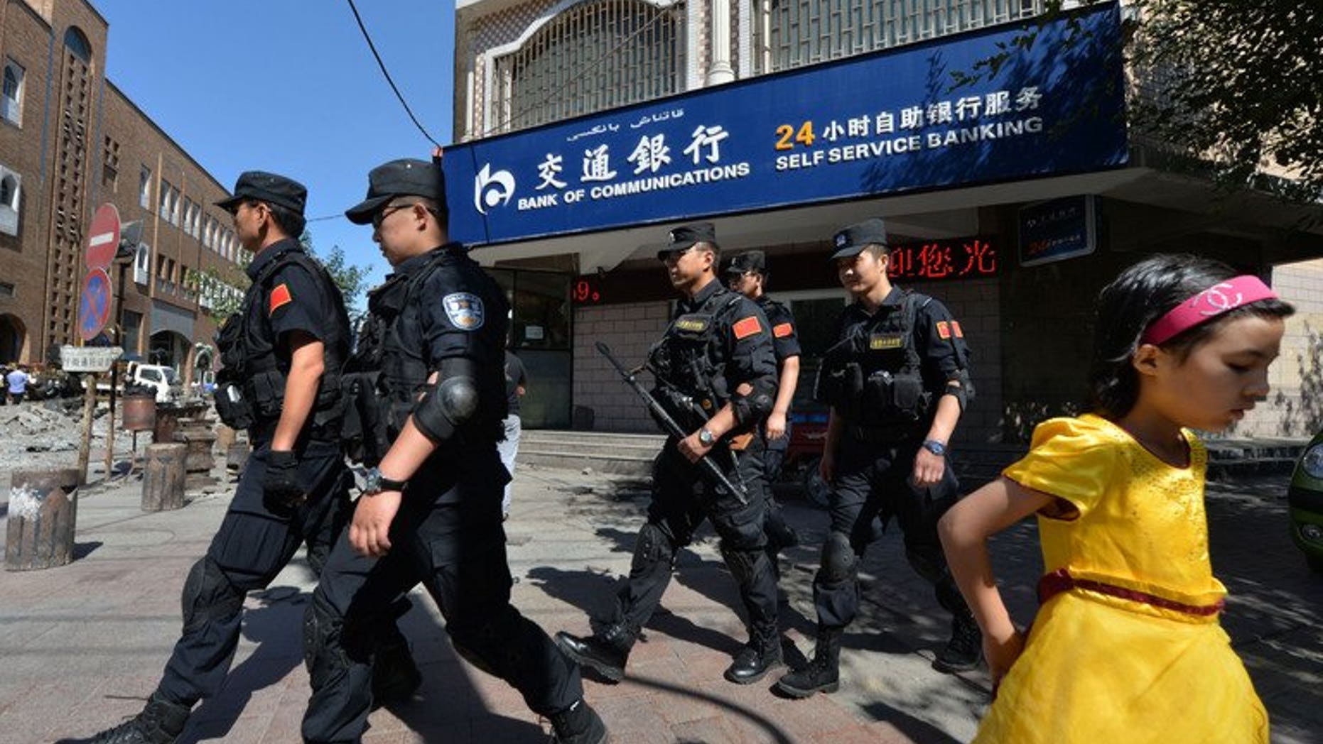 Chinese armed police patrol the streets of the Muslim Uighur quarter in Urumqi on Saturday. China staged a large military exercise in the ethnically-divided Xinjiang region on Saturday, an AFP reporter said, where clashes this week killed at least 35 people.