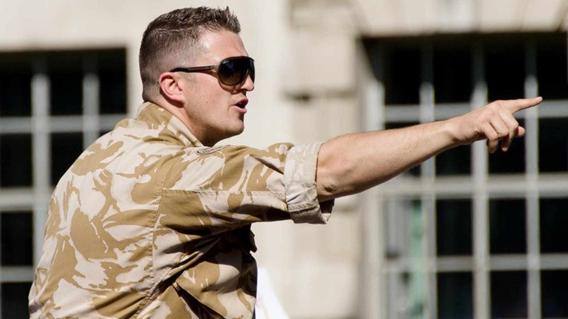 Leader of the far-right English Defence League (EDL) Tommy Robinson addresses supporters near Downing Street in London on May 27, 2013. Robinson was arrested after breaching a police order banning a march to the London site where a soldier was murdered last month, the group said.