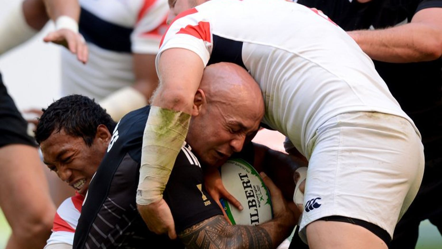 New Zealand's DJ Forbes (C) vies US Matt Hawkins (R) and US Shalom Sunisula (L) during their group stage of the Rugby World Cup Sevens 2013 match in the Luzhniki Stadium in Moscow on June 29, 2013. The All Blacks set up a quarter-final clash with defending champions Wales after surviving a scare against the United States.