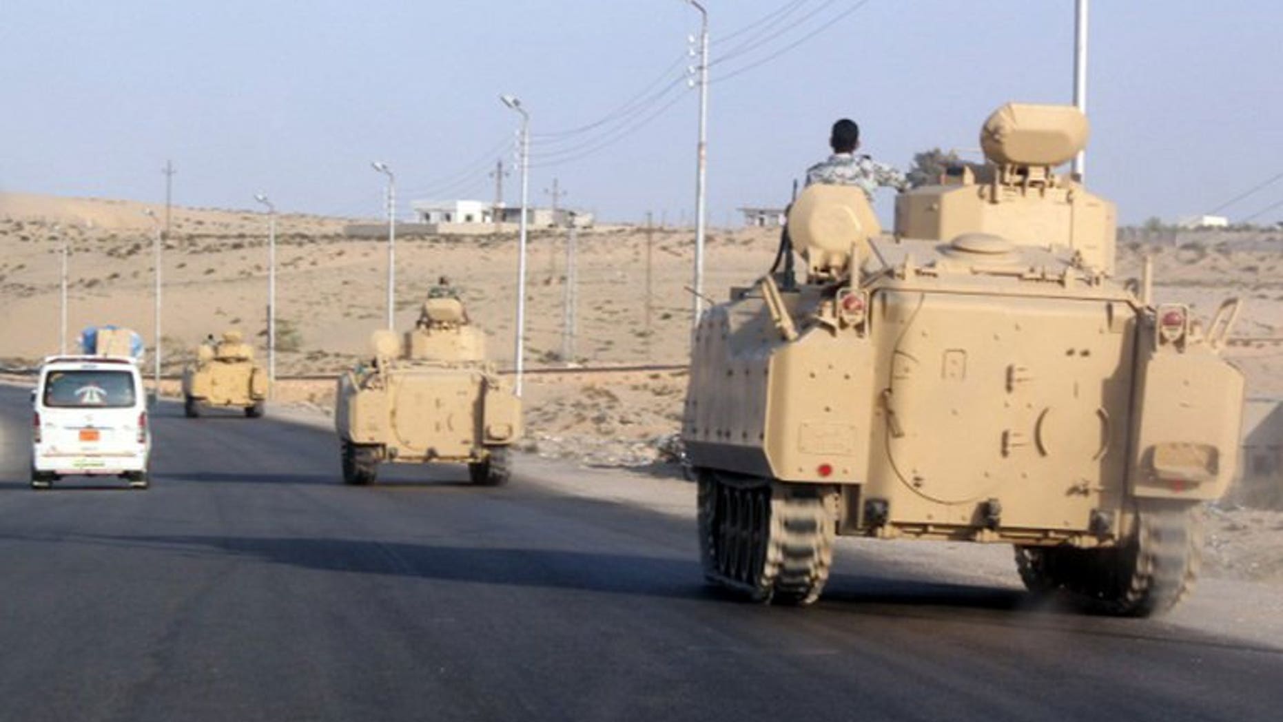 A convoy of Egyptian armoured vehicles head along a road in El-Arish in the Sinai Peninsula on August 13, 2011. Gunmen shot and killed an Egyptian police officer during an ambush Saturday in El-Arish, a security source said, the second attack on police in the restive region this month.
