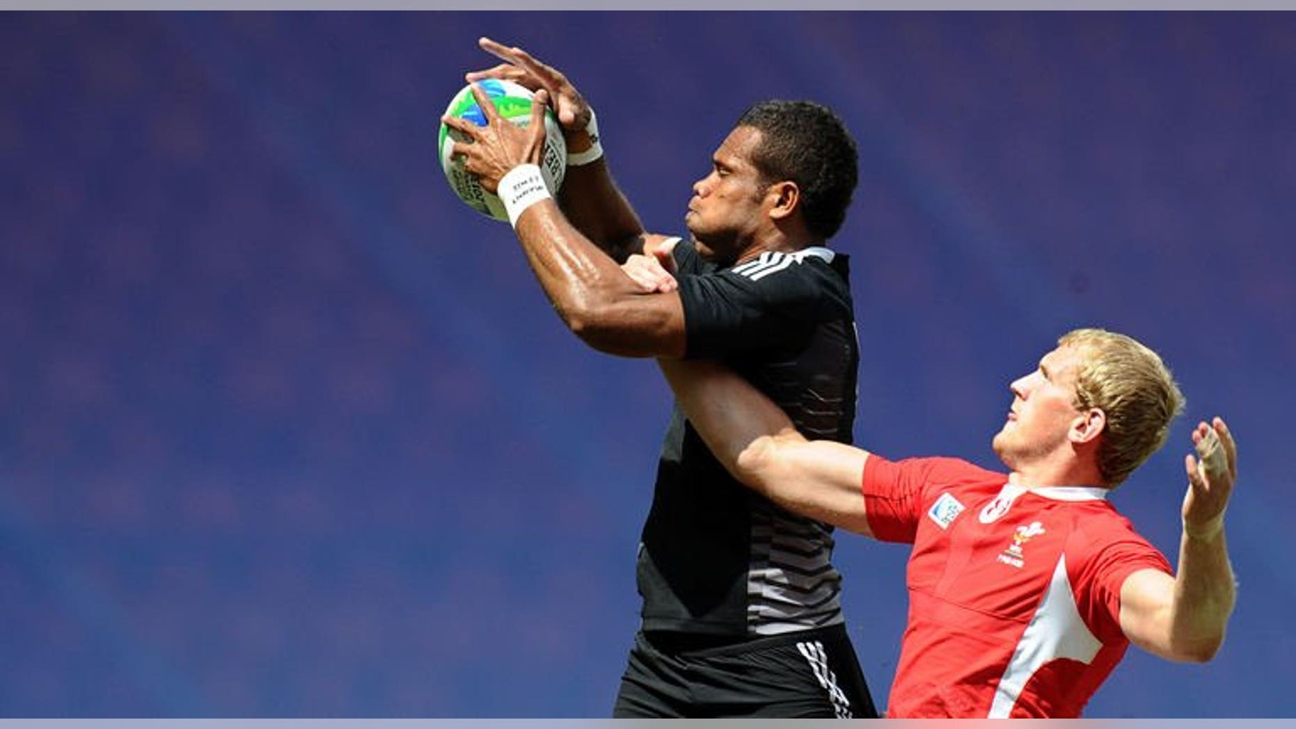 James Davies (right) of Wales vies with Tomasi Cama of New Zealand during their quarter final match at the 2013 Rugby World Cup Sevens in Moscow on June 30, 2013. New Zealand knocked defending champions Wales out of the tournament to set up a semi-final against arch-rivals Fiji.