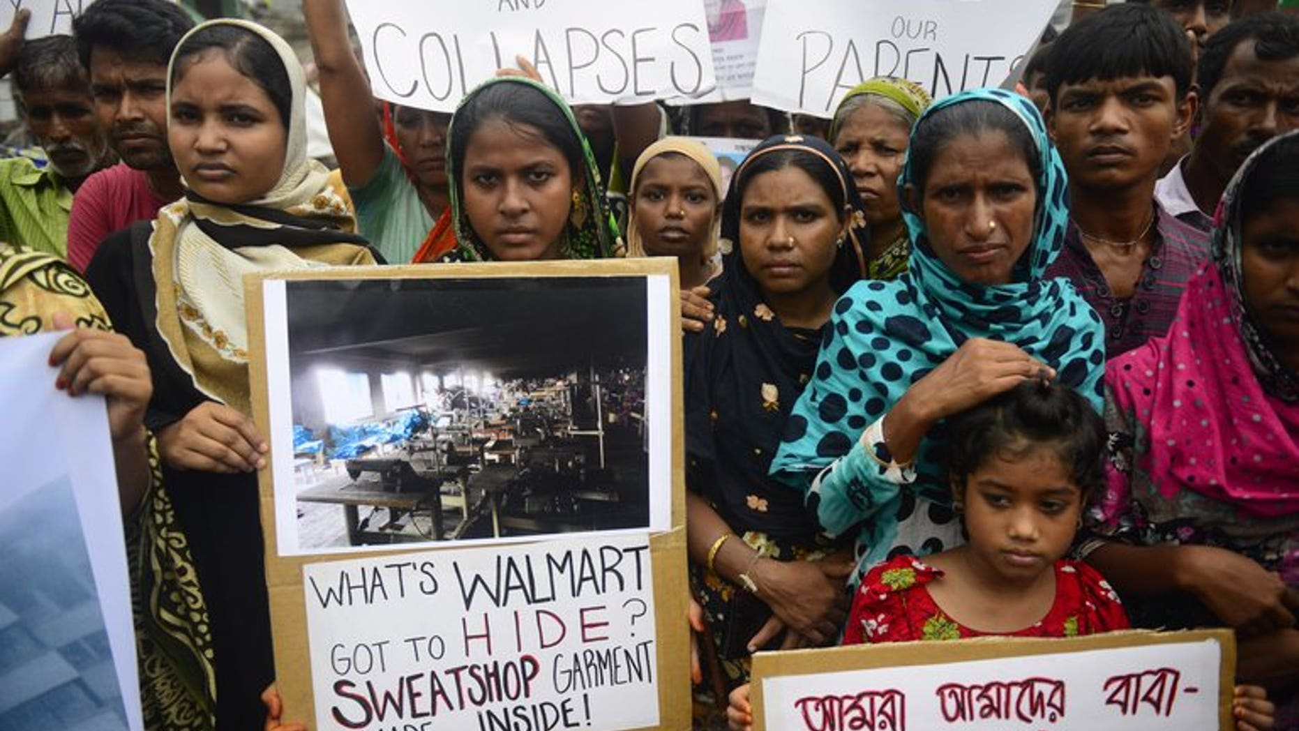 Relatives of workers who lost their lives in a garment factory disaster rally in Savar near Dhaka on Saturday. About 450 employees fell ill on Sunday after complaining of contaminated water at their workplace near the Bangladeshi capital, the second such incident to hit the same garment factory in recent days, police said.