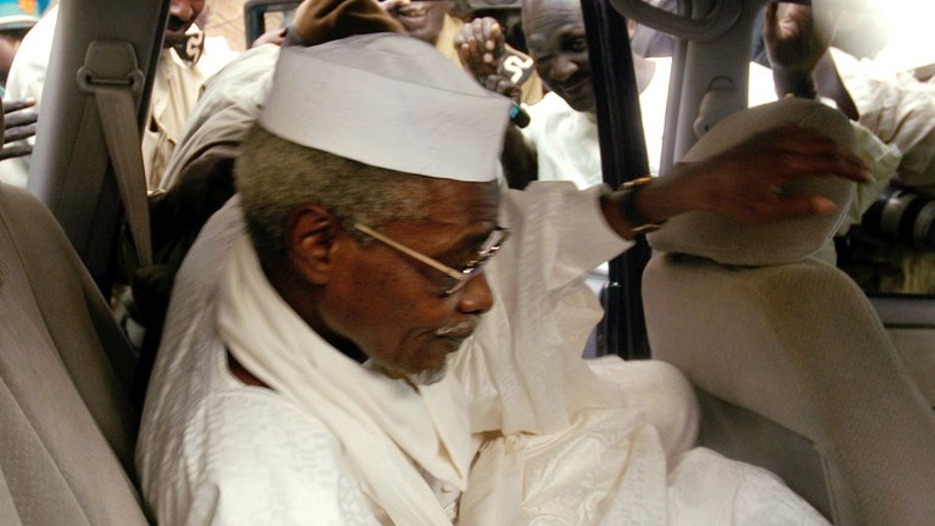 Chad's ex-dictator Hissene Habre leaves Dakar's courthouse escorted by prison guards, November 25, 2005. Habre, detained by Senegal on Sunday in the first step towards a trial for war crimes, is known as "Africa's Pinochet" for his eight-year rule over Chad which began and ended in violence.