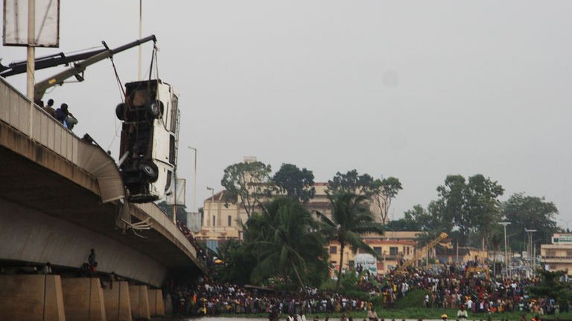 A crane retrieves a minibus from a river after it careered off a bridge just outside of Benin's capital Porto-Novo on June 30, 2013.