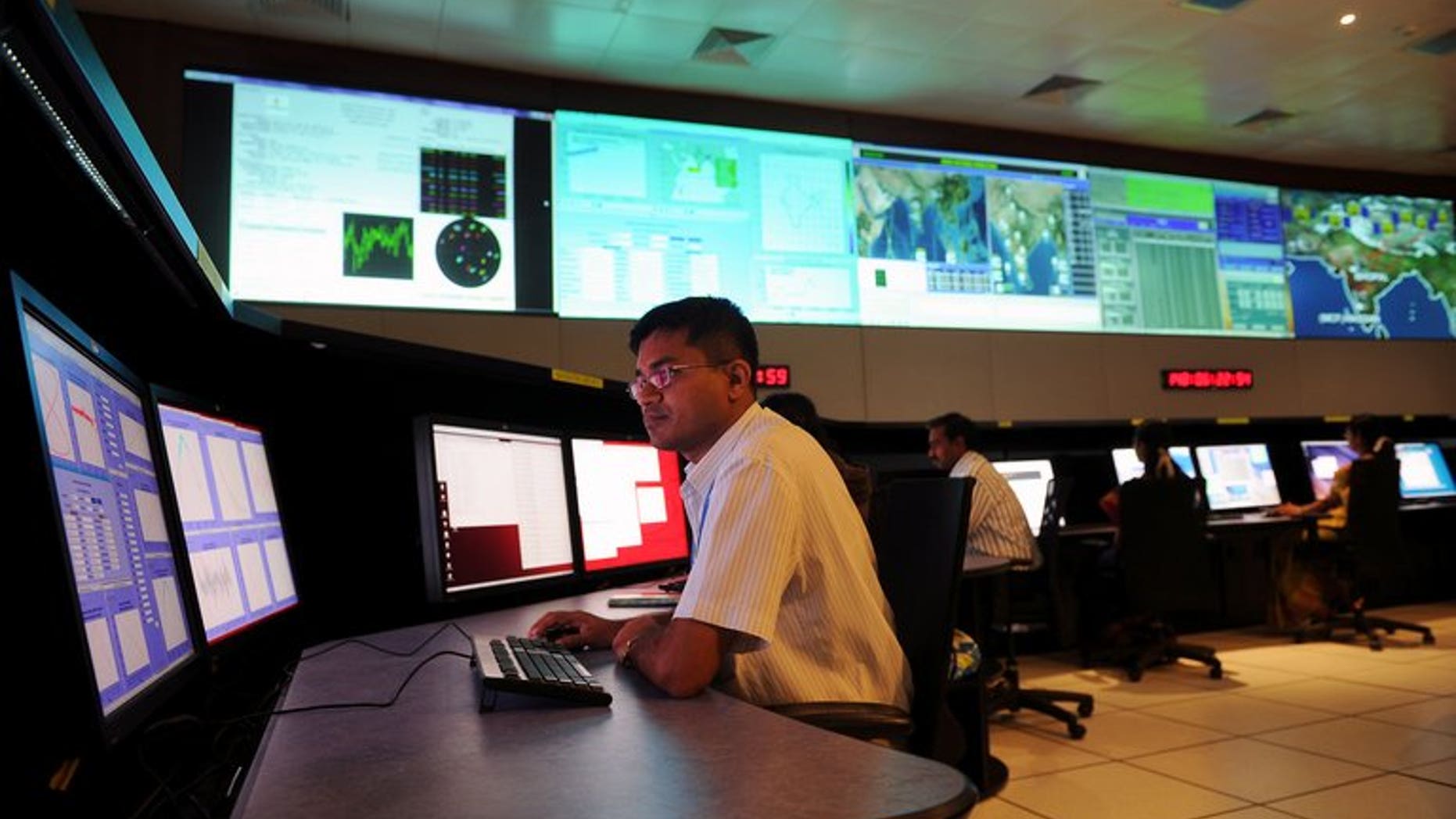 Scientists from the Indian Space Research Organisation (ISRO) work in the Indian Regional Navigational Satellite System (IRNSS) control room, at the Indian Deep Space Network (IDSN), in Byalalu village, about 50 km from Bangalore, on May 28, 2013. India will on Monday launch the first stage of IRNSS which will eventually provide services both to civilians and the military.