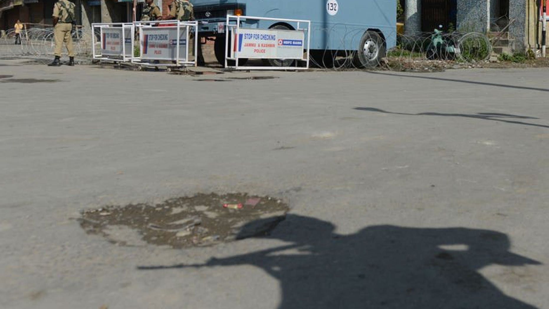 Indian paramilitary soldiers stand guard in Srinagar, on July 1, 2013. A policeman and a rebel have been killed in Indian Kashmir as the troubled region shut down to protest at the weekend shooting of two civilians by the army, a police chief said.