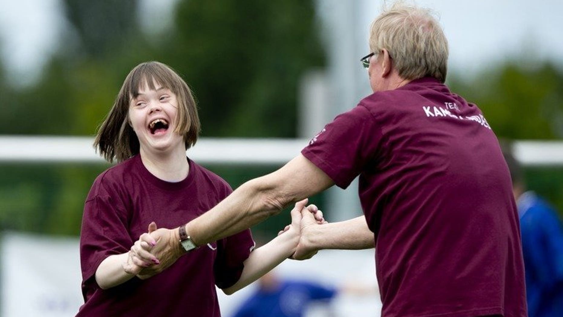 A child with Down's syndrome shares a laugh with Netherlands' TV presenter Jack Spijkerman as they take part in the 'Give Down the Future' football tournament in De Toekomst stadium in Amsterdam on June 29, 2013. A Japanese pharmaceutical company said Monday it will begin therapeutic testing of a drug it hopes will slow the decline in quality of life for some people with Down's syndrome.