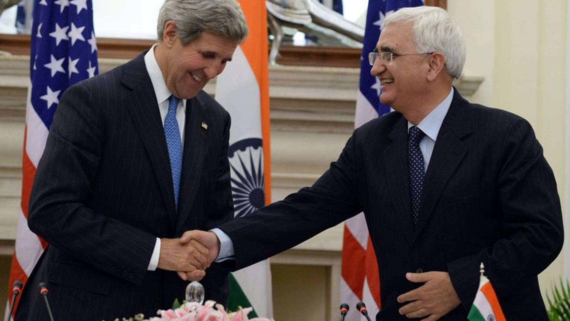 US Secretary of State John Kerry (L) shakes hands with India's foreign minister, Salman Khurshid, after a press conference in New Delhi, on June 24, 2013. Khurshid on Tuesday defended the vast US surveillance programme of phone logs and Internet data revealed by intelligence leaker Edward Snowden.