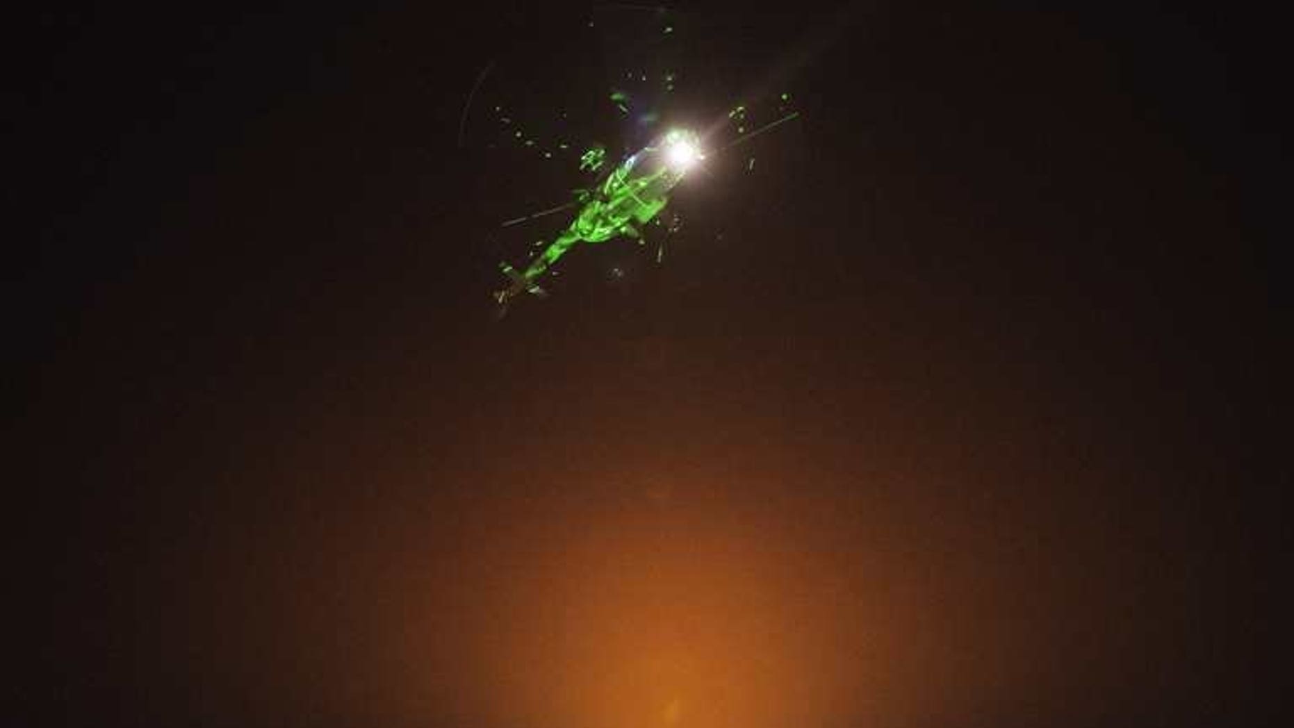 Egyptian protesters direct laser lights on a military helicopter flying over the presidential palace in Cairo, on July 1, 2013. Iran on Tuesday called on the Egyptian military to support national reconciliation and respect the "vote of the people" after it warned it was ready to intervene in Egypt's political crisis.