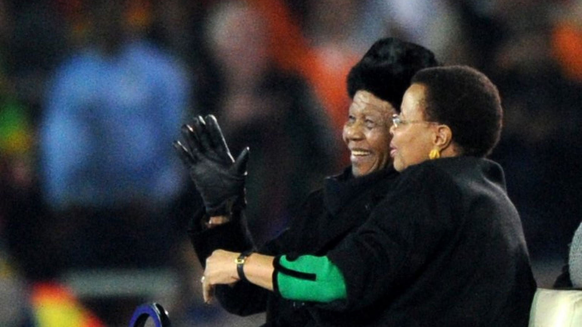 Nelson Mandela and his wife Graca Machel attend the World Cup football final at Soccer City stadium in Soweto on July 11, 2010. The South African national football and rugby union teams will play in a Soweto stadium on August 17 to honour the critically ill former president.