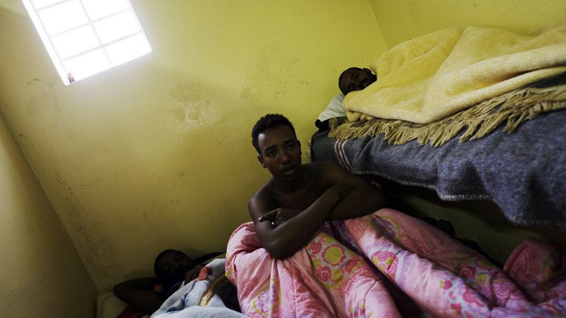 Sick Somali foreign nationals lay cramped in a toilet at a temporary refugee camp in Soetwater on the outskirt of Cape Town on June 18, 2008. A Somali envoy on Tuesday met officials in Pretoria in a bid to ease tensions stirred by recurring attacks on Somali refugees in South Africa.