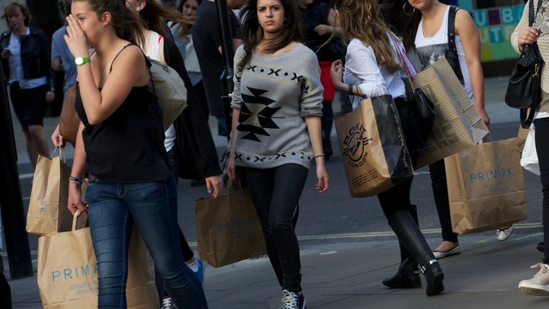 Shoppers walk along Oxford Street on April 25, 2013. Britain faces a "20-year generational battle" to restore financial stability and "at least" four more years of austerity measures, the country's top civil servant warned Tuesday.