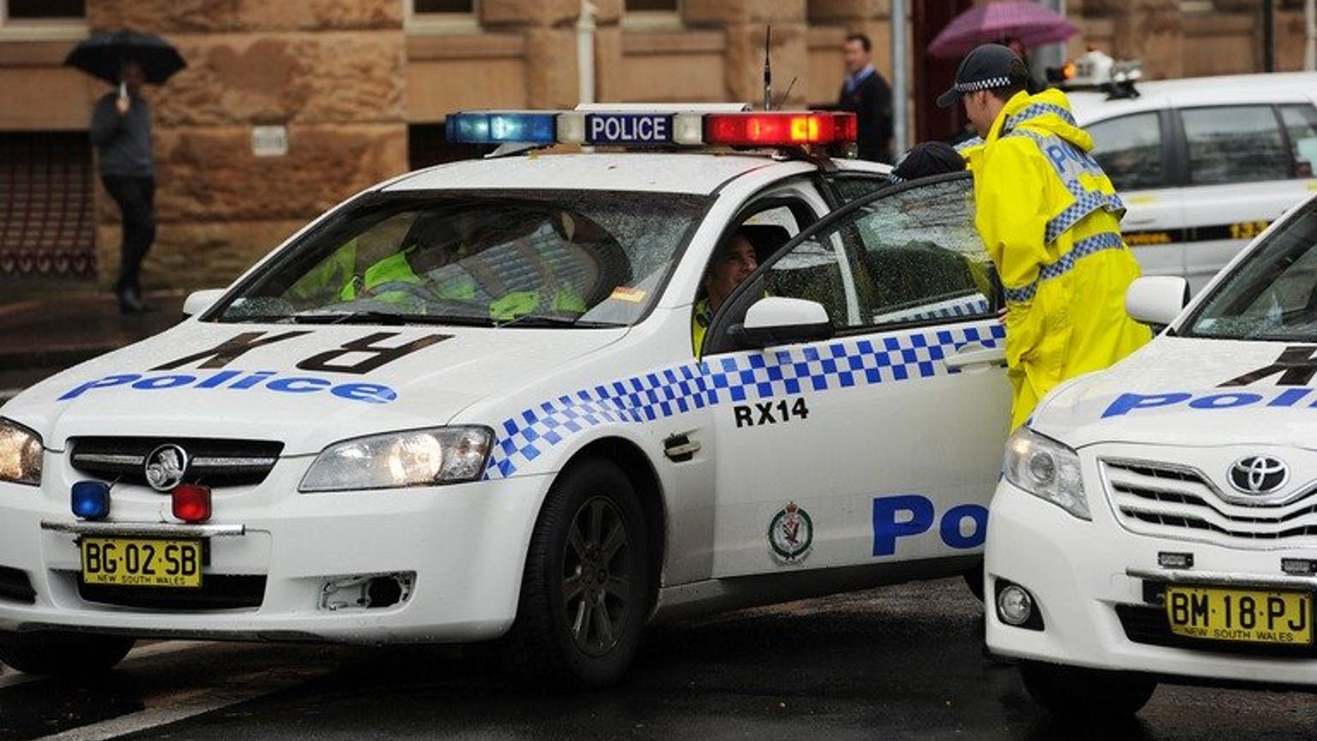 Australian police block off one end of a city street on June 13, 2012. Police described as "extremely depraved" the case of a six-year-old boy obtained by his gay male parents via a surrogate and then sexually abused by them and others.