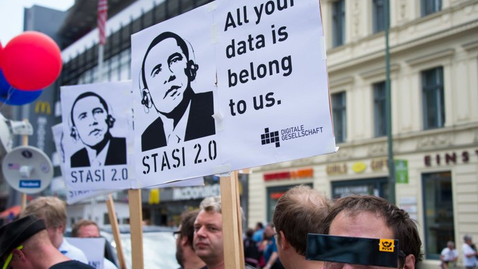 Protestors hold posters reading "Stasi 2.0" depicting US President Barack Obama wearing headphones, on June 18, 2013 in Berlin. France is calling for the temporary suspension of talks on a huge EU-US free trade pact after allegations of widespread US spying on European offices, the government's spokeswoman said on Wednesday.