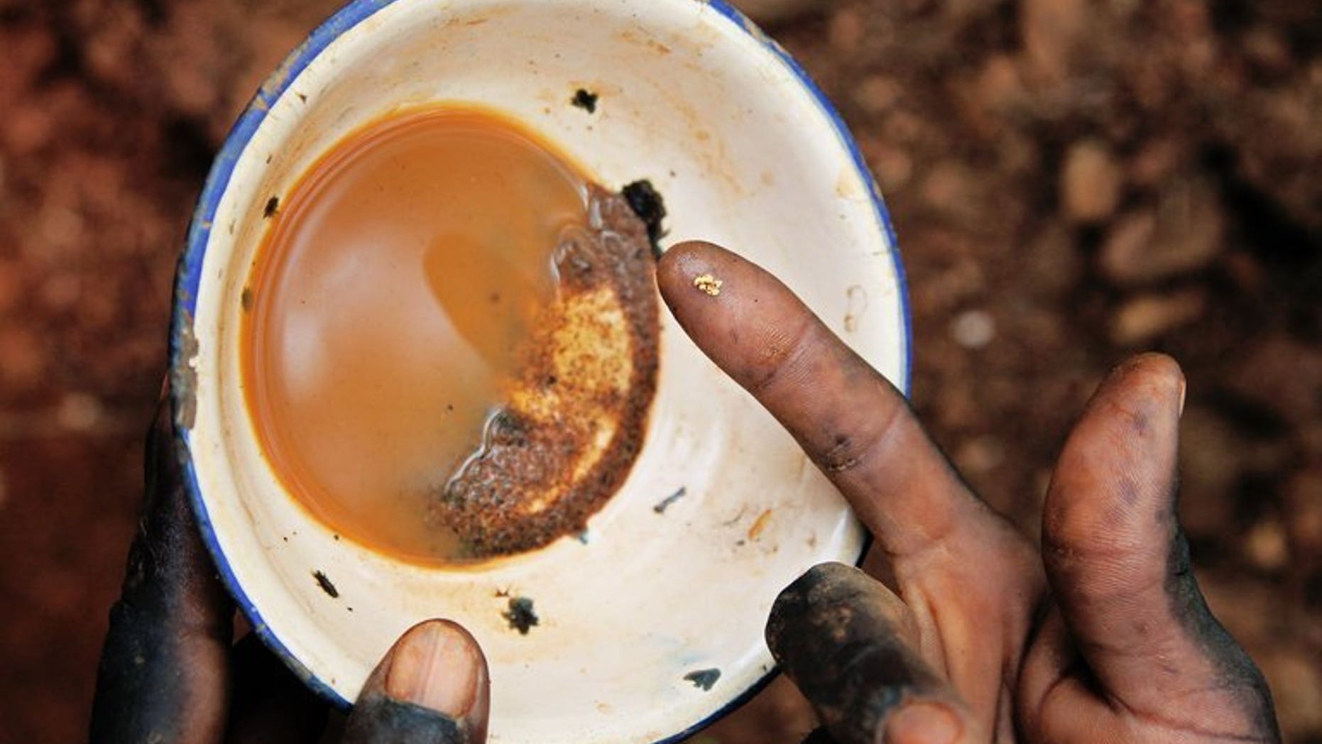 File picture shows a South Sudanese worker holding a speck of gold in Nanakanak in Greater Kapoeta, South Sudan, on May 8, 2013. A clash between Sudanese police and villagers over a gold mine killed one person and wounded several others, residents told AFP on Wednesday.