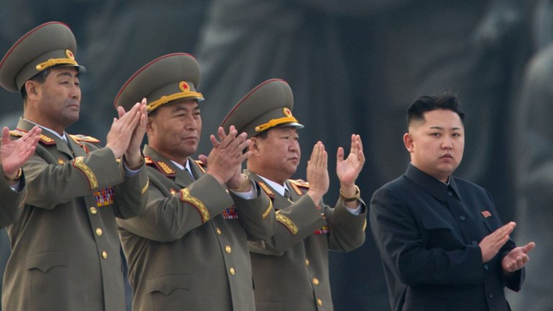 North Korean leader Kim Jong-Un (right) claps during the unveiling ceremony of two statues of former leaders Kim Il-Sung and Kim Jong-Il in Pyongyang on April 13, 2012. North Korea on Wednesday restored its official hotline with South Korea and announced it would let the South's businessmen visit a shuttered joint industrial zone, Seoul officials said.