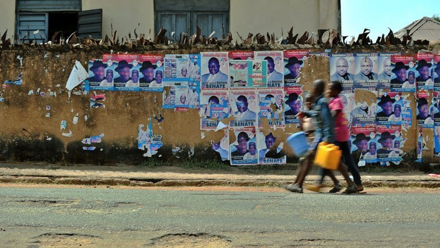 Boys walk along a street in Jos, the administrative capital of Plateau state, in Nigeria's Middle Belt region between the mainly Muslim north and predominately Christian south on April 15, 2011. A military commander claimed on Wednesday that soldiers had since last week killed more than 100 attackers responsible for a deadly raid in ethnically divided central Nigeria.