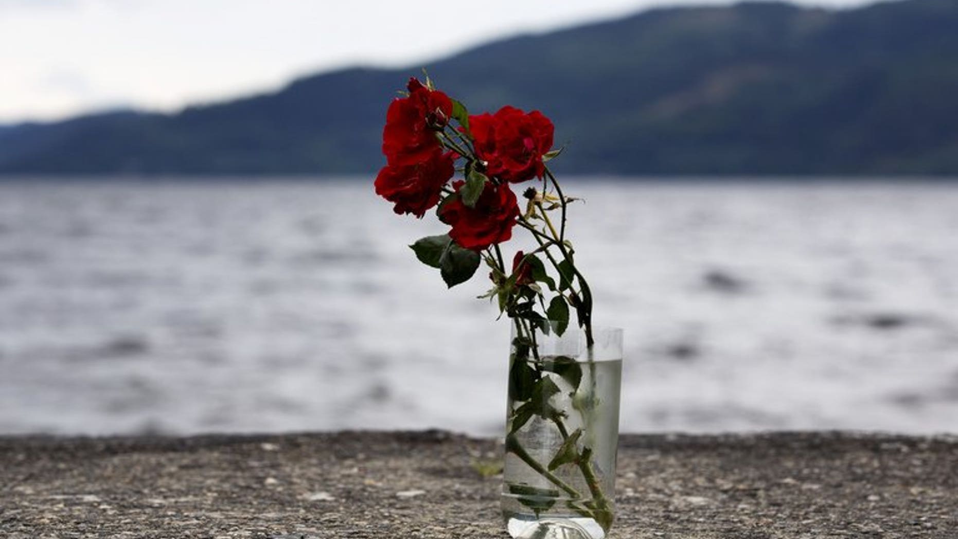 Flowers in a vase are pictured on the shores of Utoeya Island on July 22, 2012 where Anders Behring Breivik killed dozens at a Labor Party summer camp. The camp reconvened at a new site for the first time.