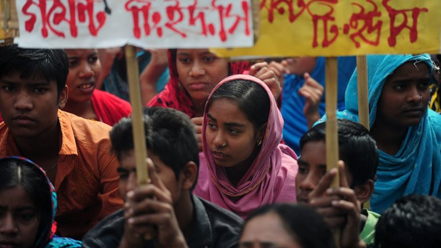 Bangladeshi garments workers and activists stage a protest in front of the Bangladesh Garment Manufactures & Exporters Association (BGMEA) office in Dhaka on January 28, 2013. Bangladesh has decided to review already announced labour law reforms after the United States last week cut its trade privileges over a deadly garment factory collapse, officials said Wednesday.