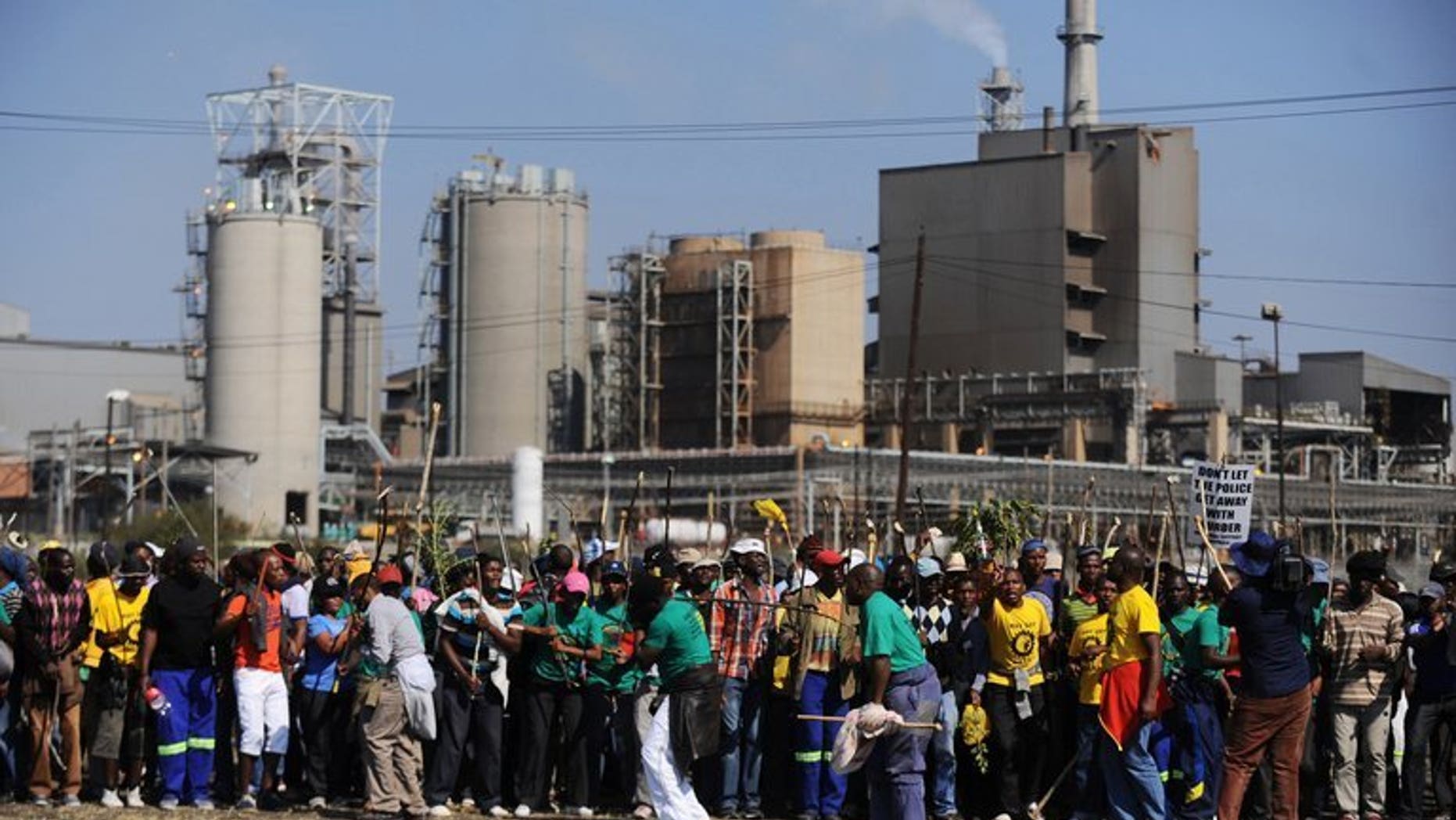 Striking Lonmin mine workers dance and sing as they gather at the Wonderkop Stadium on May 15, 2013, in Marikana during an illegal strike. Worker unions and businesses signed a government-backed peace pact Wednesday to quell violence in South Africa's restive mine sector, but compromised with a key union abstaining.