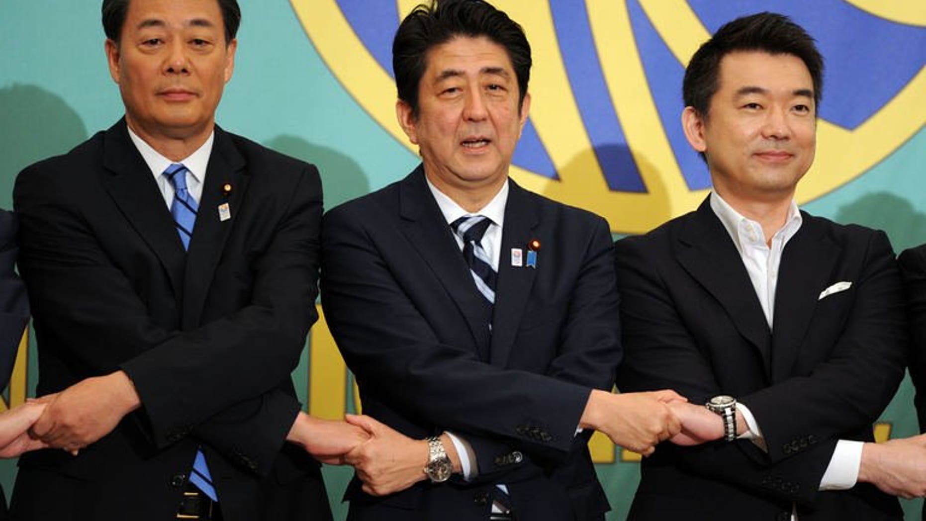 Japanese Prime Minister and ruling Liberal Democratic Party (LDP) leader Shinzo Abe (C) shakes hands with Democratic Party of Japan (DPJ) leader Banri Kaieda (L) and co-leader of Japan Restoration Party Toru Hashimoto prior to their political debate in Tokyo on July 3, 2013. Campaigning begins Thursday in an election expected to give Abe an almost unbeatable hand.