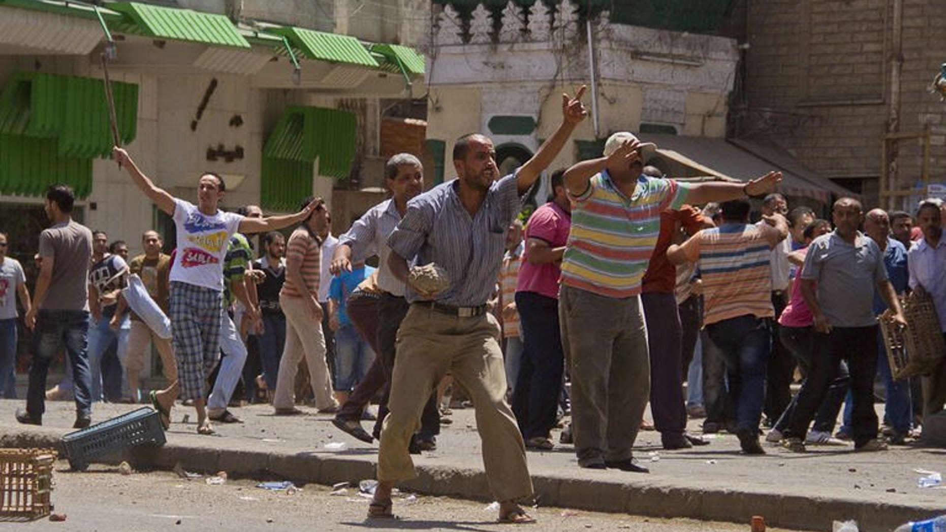Egyptian opposition protestors hold stones and sticks during clashes with supporters of President Mohamed Morsi in the northern port city of Damietta on June 3, 2013. Elsewhere, four supporters of ousted Egyptian president Mohamed Morsi were killed on Wednesday in clashes with the army and police in the western city of Marsa Matruh, a security official told AFP.