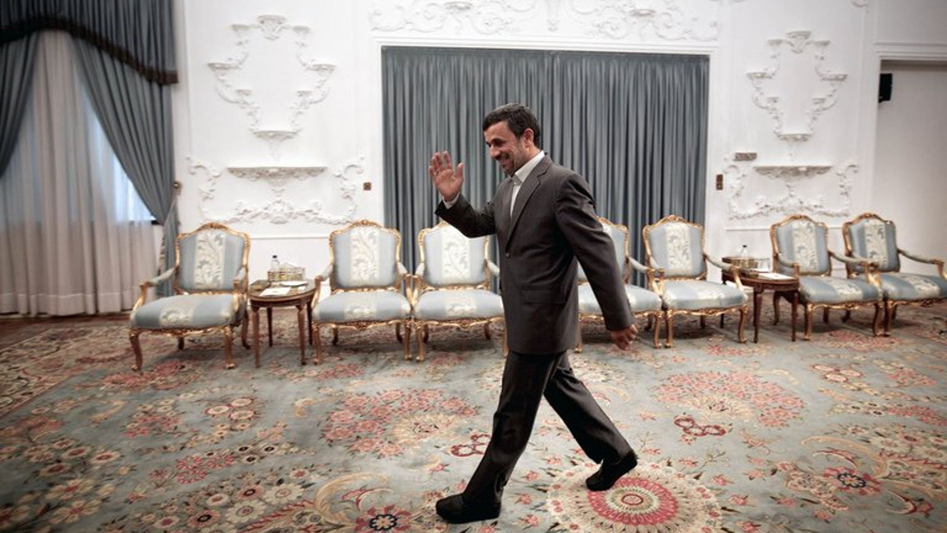 Iranian President Mahmoud Ahmadinejad waves as he arrives for a meeting in Tehran on June 23, 2013. Ahmadinejad on Wednesday defended his government's rights record, saying he was not responsible for other branches of the Islamic regime.
