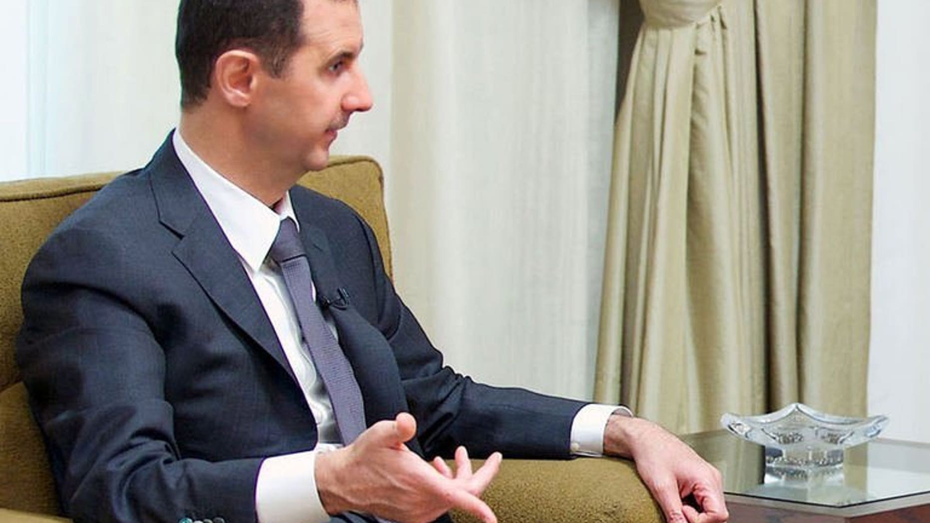 A handout picture released by the Syrian Arab News Agency (SANA) shows President Bashar al-Assad giving an interview to a local newspaper in Damascus, on July 2, 2013. Assad has accused the West of sending "takfiri terrorist groups" to his country as a way to get rid of them, in an interview with a Syrian daily.