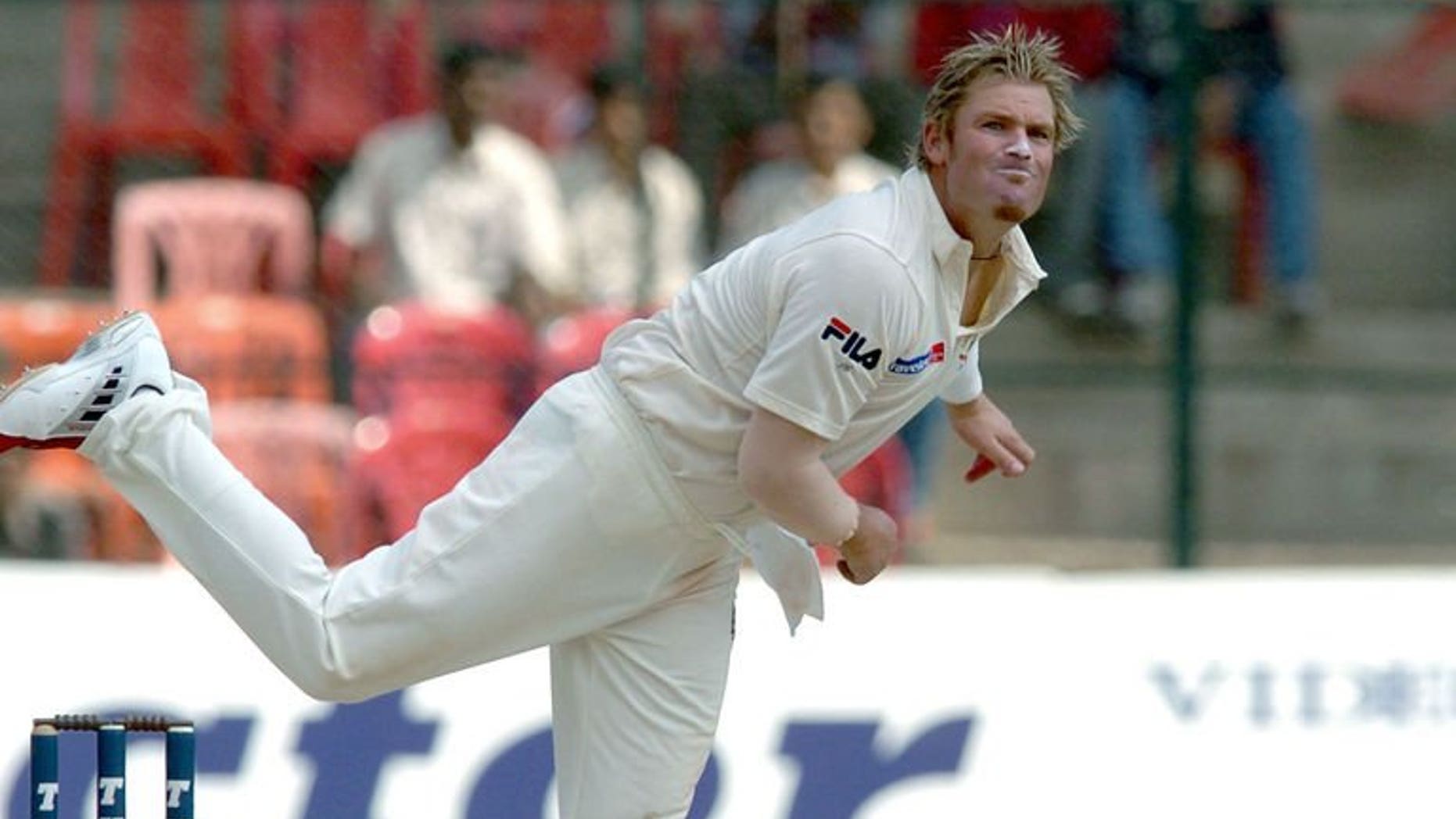 Australian cricketer Shane Warne bowls to Indian vice-captain Rahul Dravid during a Test match in Bangalore, October 10, 2004. Twenty years ago, Warne flighted the "Ball of the Century" that famously bamboozled England's Mike Gatting and reminded everyone of the marvels of leg-spin bowling.