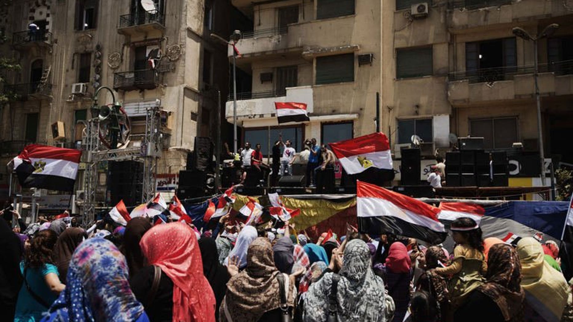 Egyptians cheer and wave their national flag as they gather in Cairo's landmark Tahrir Square on July 4, 2013. Governments across the Middle East have welcomed the ouster of Egypt's Islamist president Mohamed Morsi with varying degrees of enthusiasm, with war-hit Syria calling it a "great achievement".