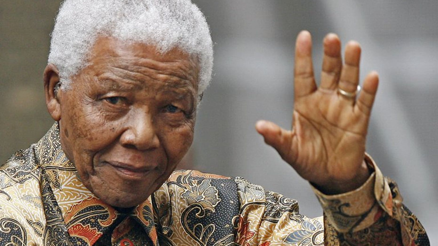 Nelson Mandela waves to the media as he arrives outside No 10 Downing Street in central London, on August 28, 2007. Doctors treating Mandela said that he was in a "permanent vegetative state" and advised his family to turn off his life support machine, according to court documents dated June 26, obtained by AFP.