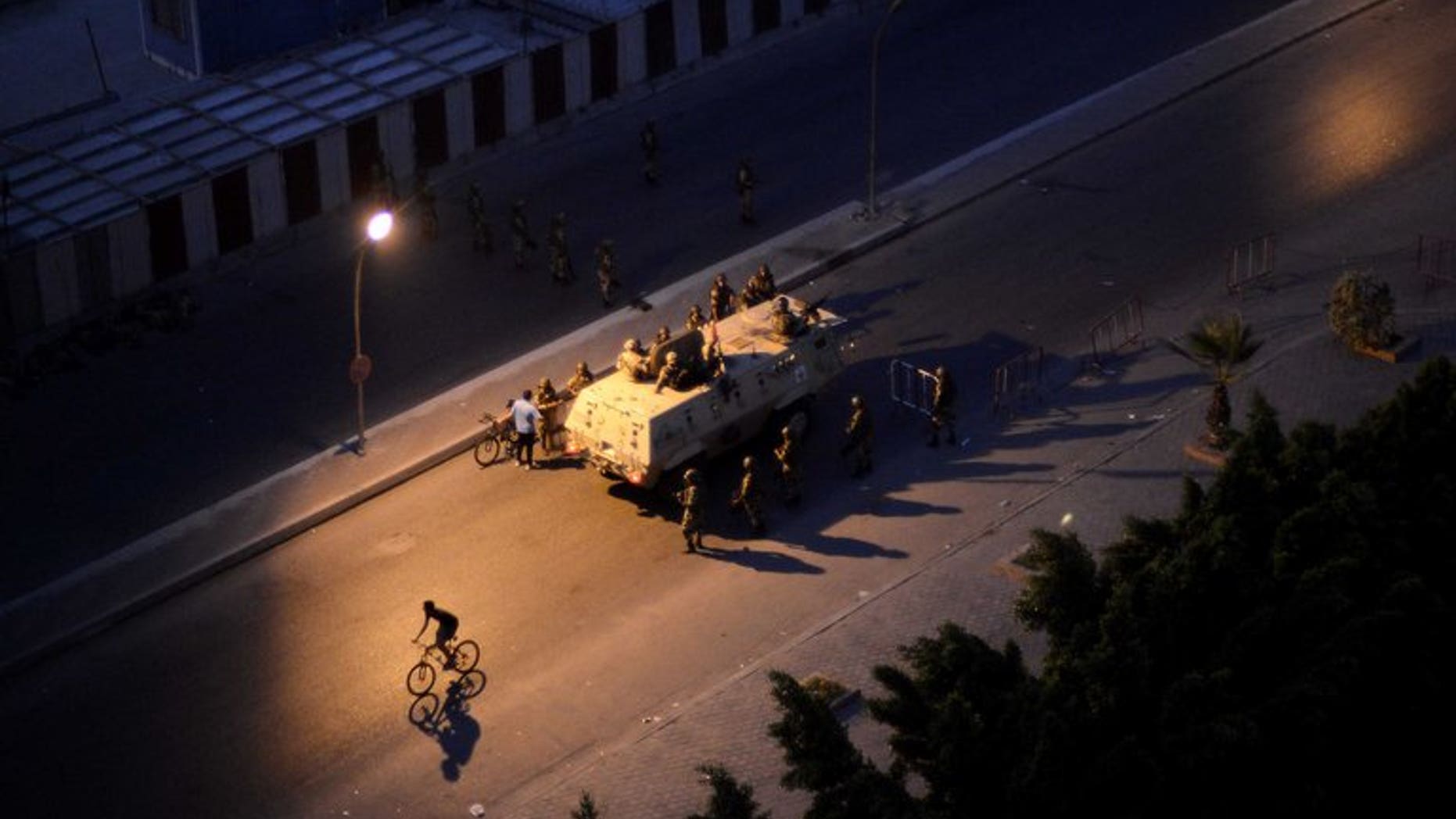 An Egyptian army armored personnel carrier and soldiers are stationed on a street in Cairo following the toppling of ousted Egyptian president Mohamed Morsi on July 4, 2013. An alliance of Islamist parties and movements including ousted president Mohamed Morsi's Muslim Brotherhood has called for "peaceful protests" on Friday to denounce the military's overthrow of the Islamist president.