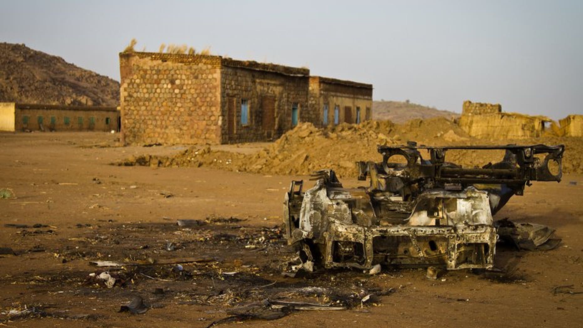 The shell of a vehicle that was hit by a bomb in the abandoned village of Trogi during fighting in South Kordofan, Sudan, is pictured on April 3, 2012. An advance party of UN troops who will support the monitoring of a buffer zone along the disputed Sudan-South Sudan border should arrive by August, the top UN peacekeeper said on Thursday.