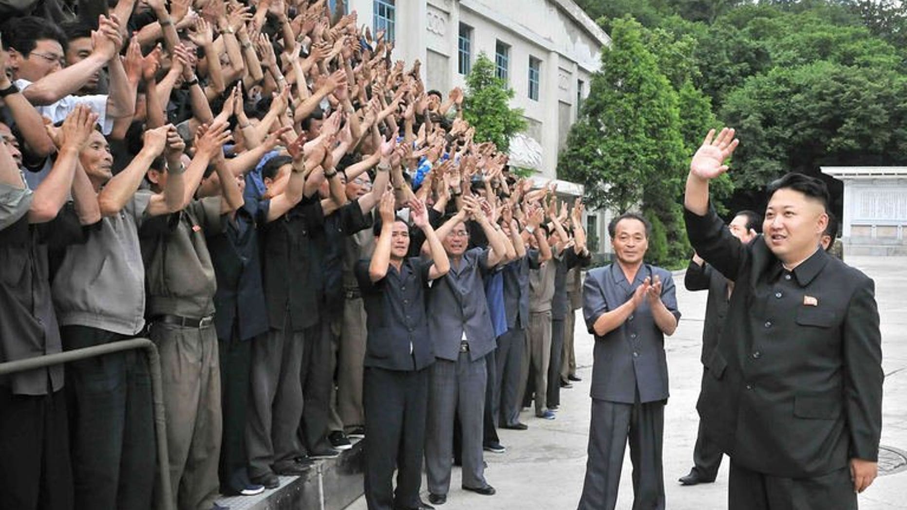 North Korean leader Kim Jong-Un waves to employees at the Kongdong Precision Machine Plant in Pyongyang, in a photo released by North Korea's official Korean Central News Agency on July 5, 2013. Russia said Friday it still had "a number of substantial" differences with North Korea concerning efforts to resume stalled six-party negotiations on the Stalinist state's nuclear weapons drive.